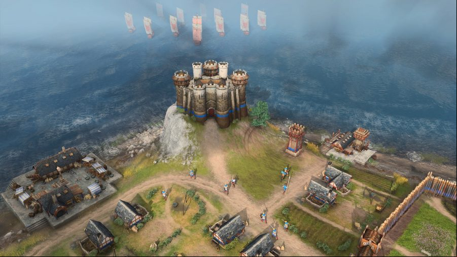 A keep on a hill looking out over the sea in age of empires 4 as a fleet of ship approaches