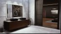 Vampire The Masquerade Swansong review: an official screenshot from Big Bad Wolf depicts a bathroom in a modern, minimalist apartment, the residence of a wealthy Boston banker; a large smart mirror depicts the day's weather over two granite sinks, and the walls and floor tiles are of pristine white marble