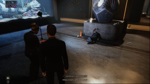Vampire The Masquerade Swansong review: as Galeb, a Ventrue vampire in a svelte suit, the player explores the hallway of a luxurious Boston apartment, where there has been a muder; Galeb speaks with a police lieutenant as they survey a decapitated corpse, slumped against a modern abstract sculpture; a fish tank decorates one wall, and the floor is glossy marble