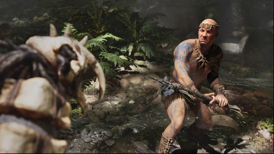 Ark 2 release date window: a man who looks like Vin Diesel is brandishing a spear to fight against a dinosaur.
