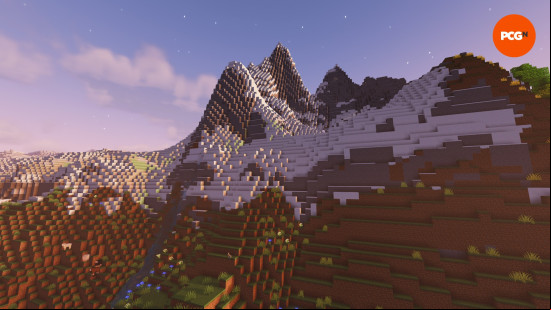Minecraft biomes: The sun sets over the snowy peaks of a Minecraft mountain.