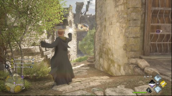Hogwarts Legacy flying pages - a Hufflepuff wizard is using the Accio spell to lure in a flying page. He's standing between two cobblestone buildings in Hogsmede.