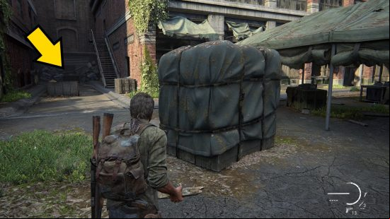 The Last of Us Firefly Pendants locations: a man stands in front of a large, wrapped container.