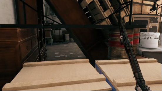 The inside of the garage containing the Dead Island 2 Curtis garage key, stacked with crates, barrels, and tins of paint, with a small gap to squeeze into the other side.