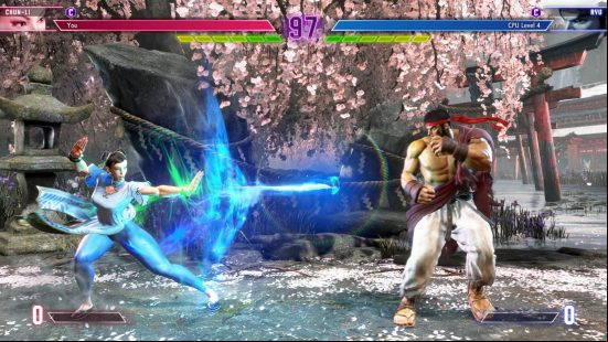 Street Fighter 6 Chun-Li is firing a Kikoken at Ryu.