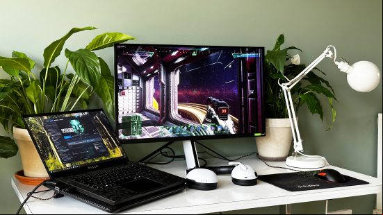Sony Inzone M9 monitor and a gaming laptop on a desk with plants