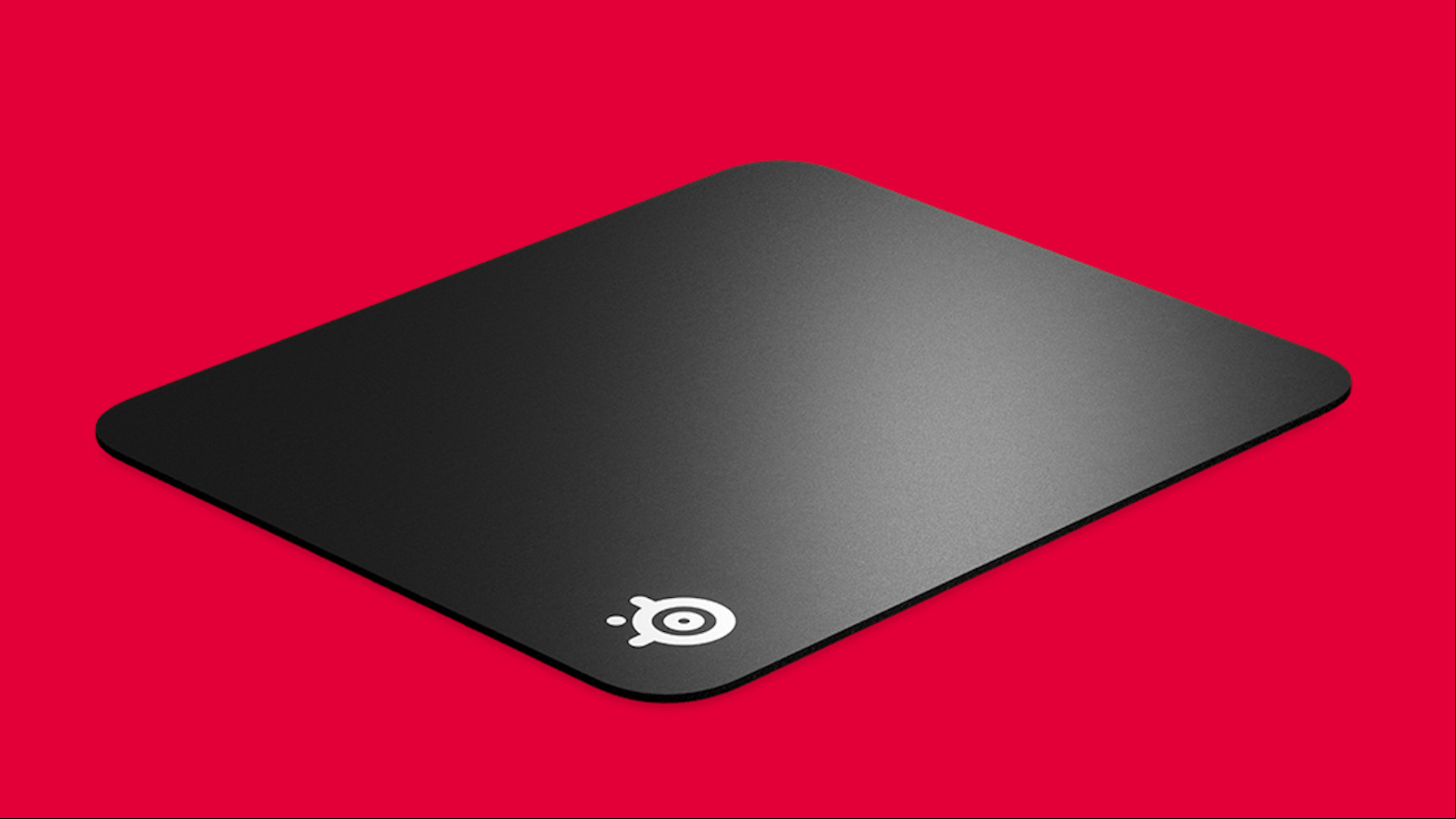 Hard vs soft mouse mat gaming: A hard Steelseries mouse mat on a red background