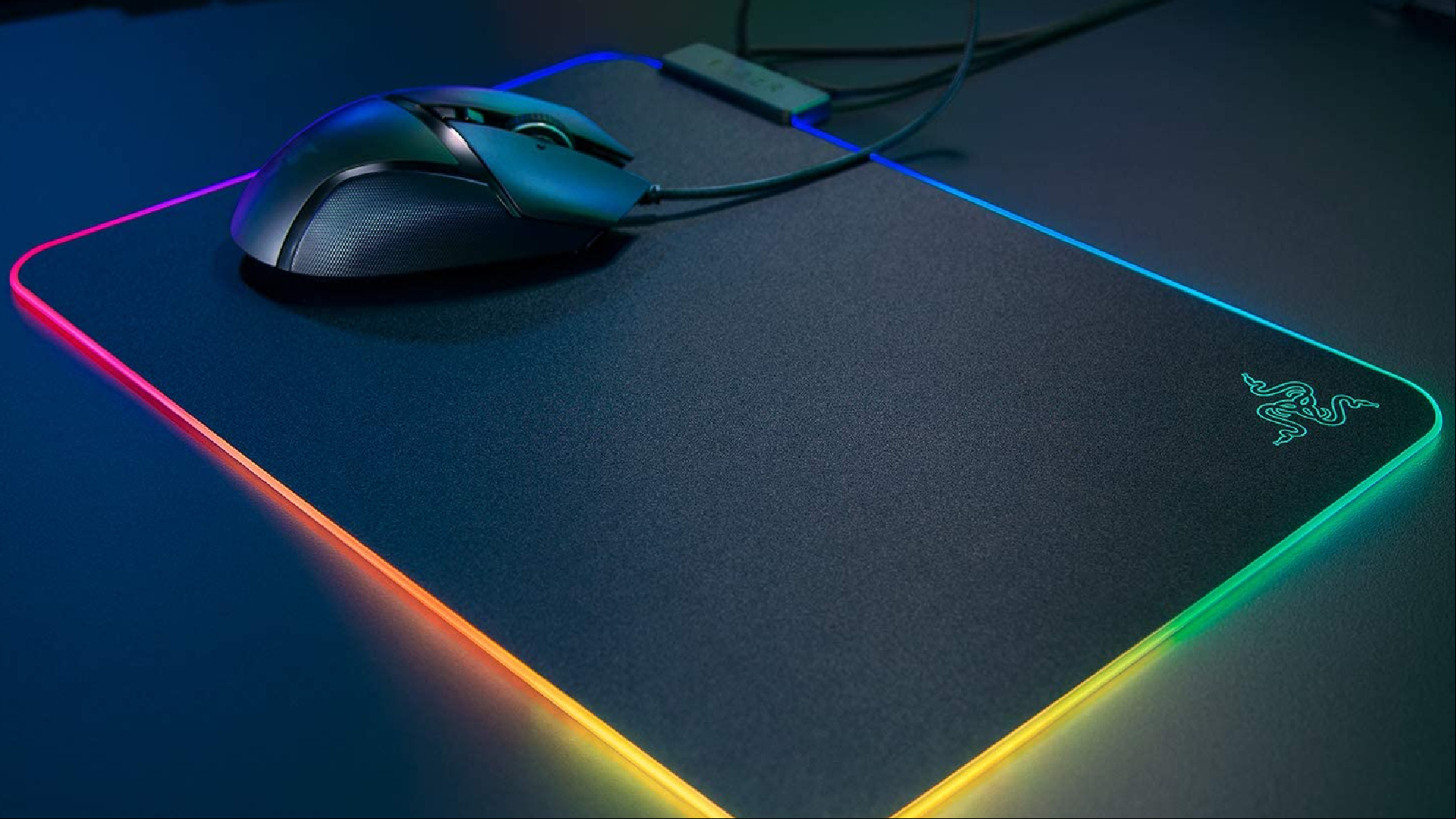 soft vs hard mouse pad: A Logitech mouse sits on a RGB lit mouse pad