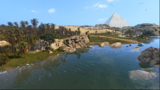 The river nile with a pyramid in the distance and a clear blue sky overhead.