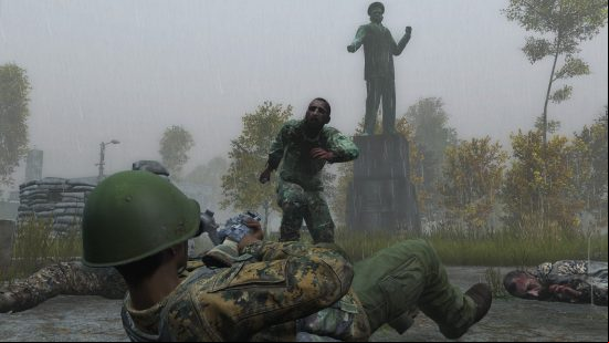 DayZ: a man on his back firing a weapon at a zombie.