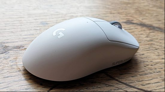 Logitech G Pro X Superlight 2 gaming mouse review: a white Logitech mouse, viewed from behind, sits on a wooden surface.
