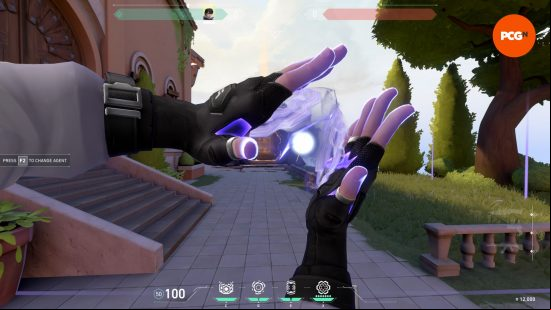 A pair of hands with black fingerless gloves conjure fluid purple energy in an idyllic town square setting