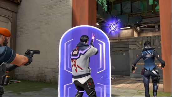A man wearing a white bomber jacket and black jeans stands behind a prismatic energy shield shooting at a purple orb in the sky