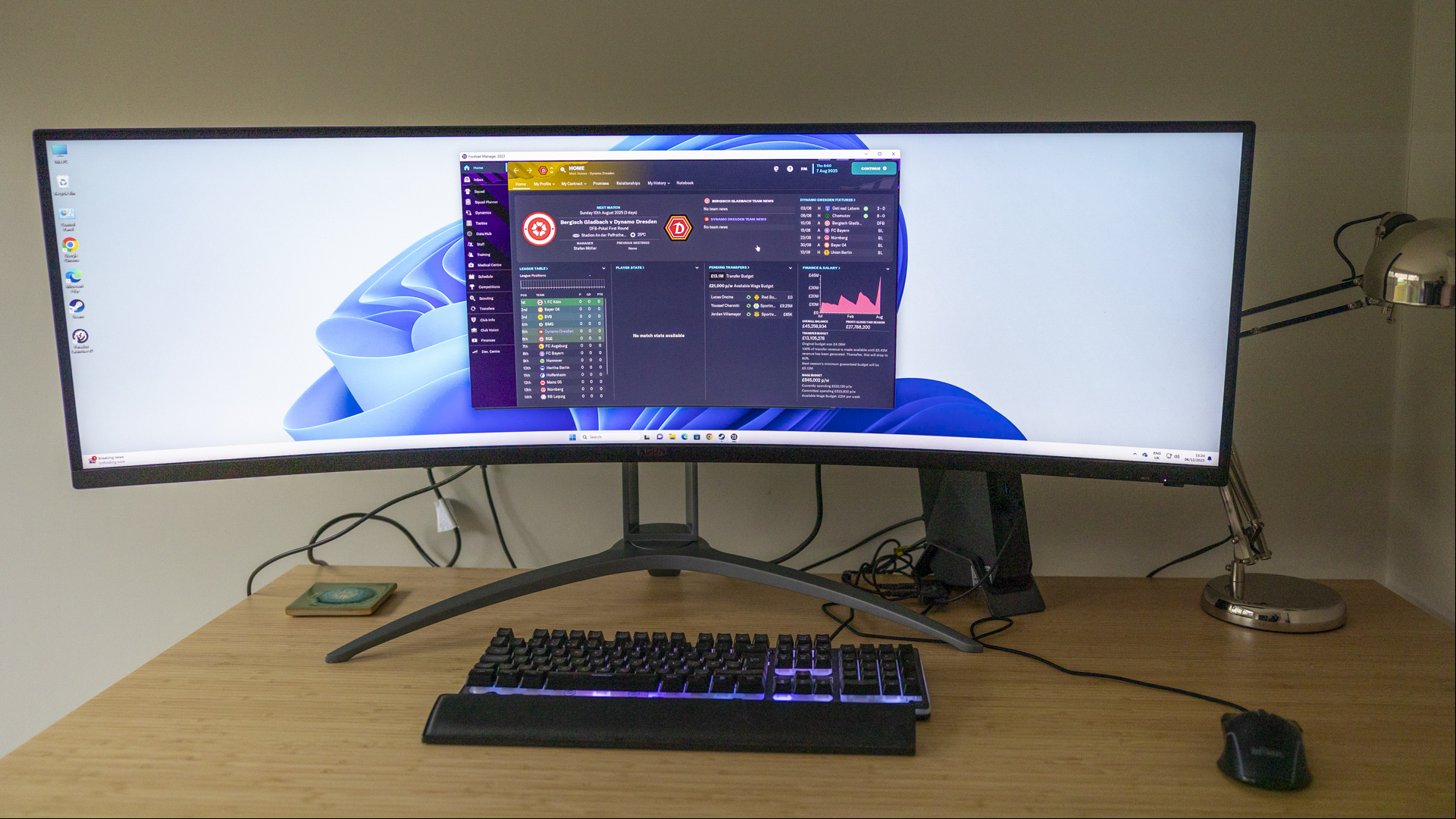 The AOC Agon AG493UCX2 monitor on a bamboo desk