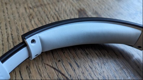 LucidSound LS100X review: a black gaming headset sits on a wooden table.
