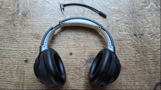 LucidSound LS100X review: a black gaming headset sits on a wooden table.