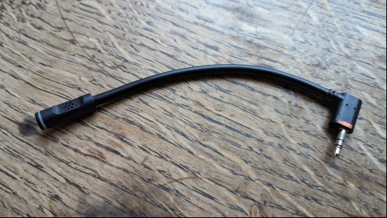 LucidSound LS100X review: a black gaming headset sits on a wooden table.