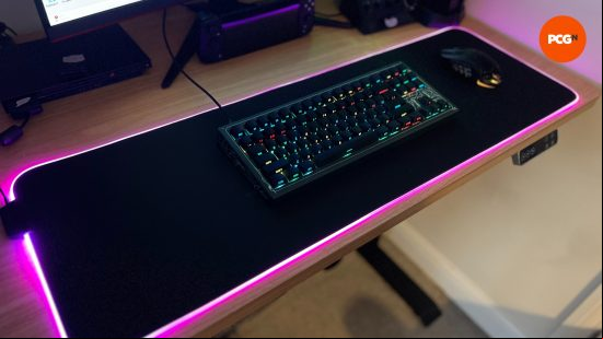 a wide image showing the whole SteelSeries QcK Prism XL with peripherals on it