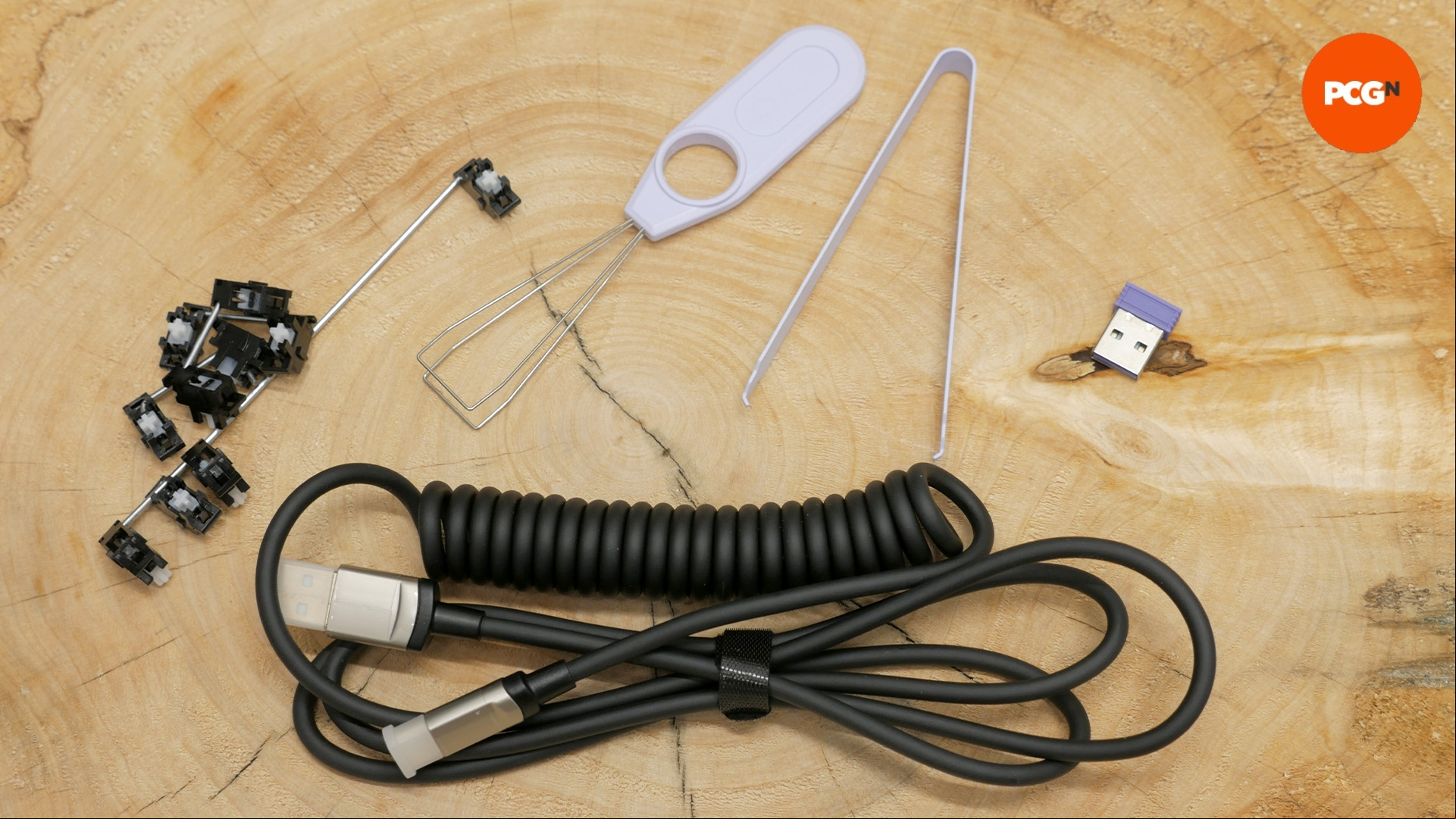 Monsgeek M1W SP review image showing the dongle stabs removal tool.