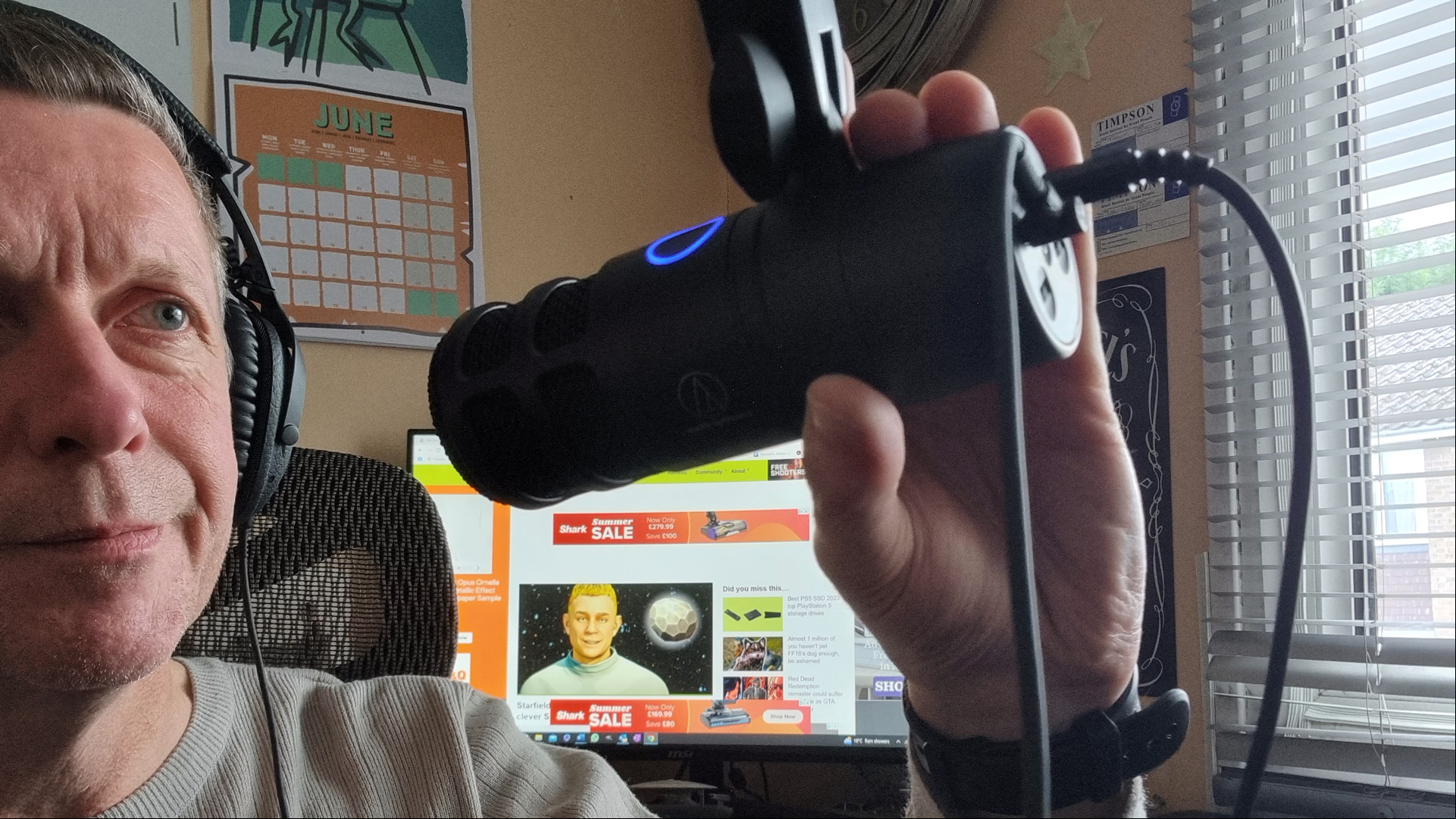 Audio Technica review image showing the microphone being held by a model.