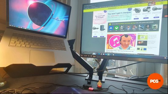 Secretlab Magnus Pro review image showing is monitor arms with a laptop and monitor in place.