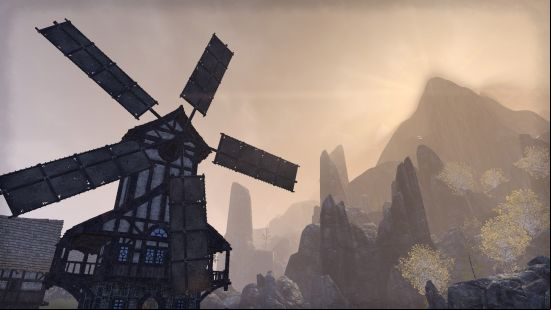 A scene from ESO with a windmill turning against a misty mountain in the distance.
