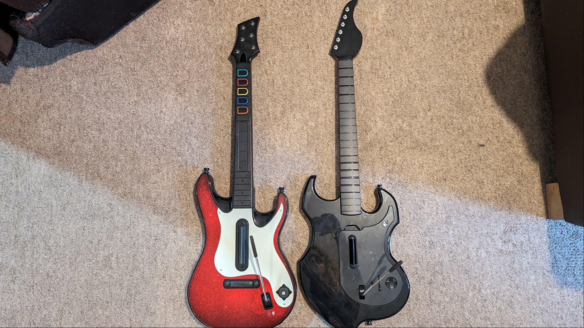 PDP Riffmaster Guitar controller review image showing the guitar beside a Xbox 360 Guitar Hero controller.