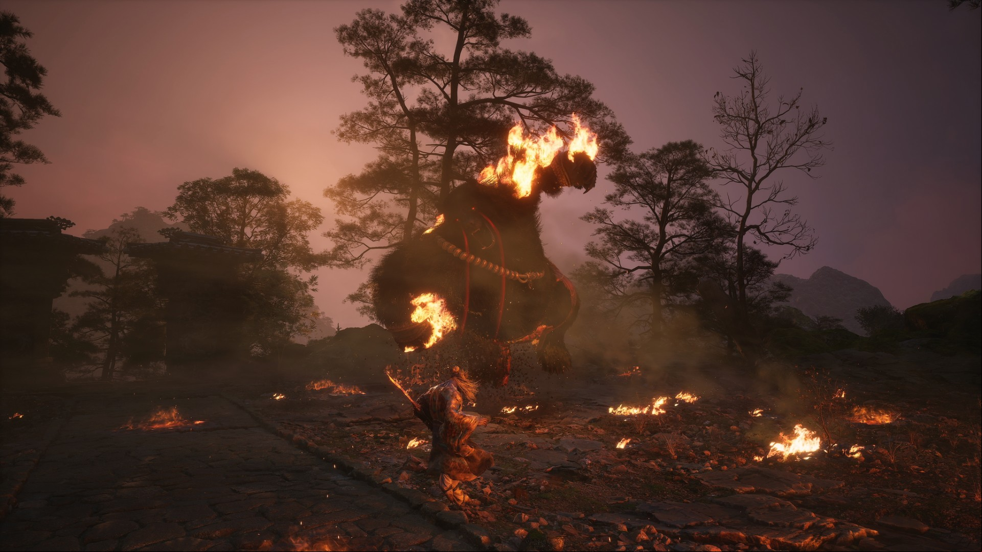 Black Myth Wukong preview: Wukong fighting a giant flaming bear boss.