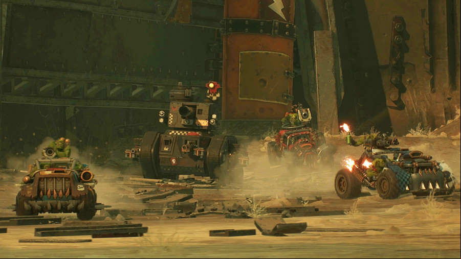 Warhammer 40k Speed Freeks: A convoy of vehicles drive by orks move across a dusty terrain