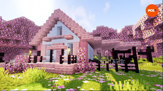 A pink and white Minecraft house built from cherry wood.