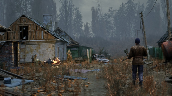 Best survival games: a solitary man walks towards a campfire located next to a dilapidated building.