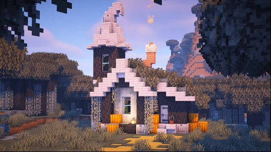 A gray, white, and orange Minecraft house build within a Pale Garden biome.
