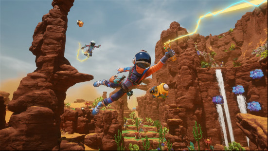Two players flying over a desert in Revenge of the Savage Planet.